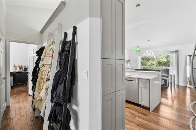 10000 SW 52nd Ave Unit 164, Gainesville, FL 32608 - hall featuring a chandelier, light wood-style floors, and lofted ceiling