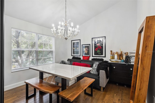 dining space with dark hardwood / wood-style flooring, a chandelier, vaulted ceiling, and a wealth of natural light