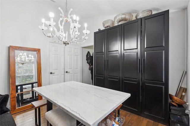 dining area featuring an inviting chandelier and dark hardwood / wood-style floors