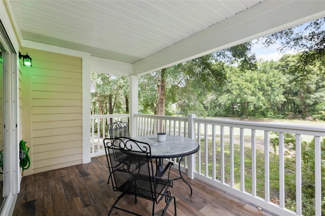 10000 SW 52nd Ave Unit 164, Gainesville, FL 32608 - deck with outdoor dining space and view of wooded area