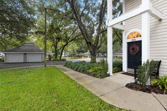 10000 SW 52nd Ave Unit 164, Gainesville, FL 32608 - view of grassy yard with a garage