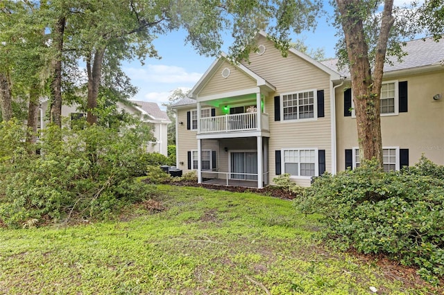 10000 SW 52nd Ave Unit 164, Gainesville, FL 32608 - rear view of property with a balcony and a lawn