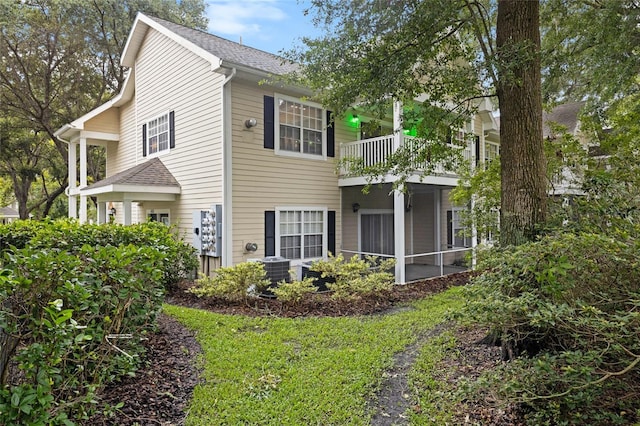 10000 SW 52nd Ave Unit 164, Gainesville, FL 32608 - view of side of home featuring a balcony and roof with shingles