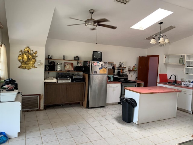 kitchen with sink, ceiling fan with notable chandelier, electric stove, stainless steel fridge, and white cabinets