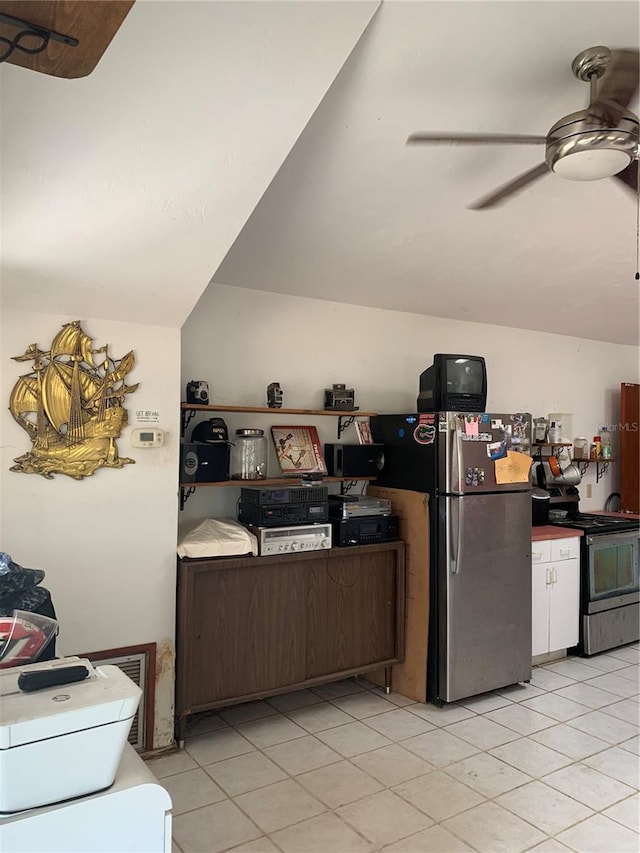 kitchen with dark brown cabinets, appliances with stainless steel finishes, light tile patterned floors, and ceiling fan