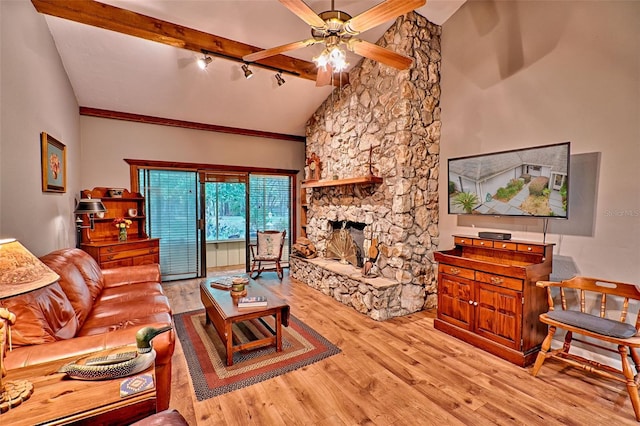 living room with beam ceiling, ceiling fan, high vaulted ceiling, light wood-type flooring, and a fireplace