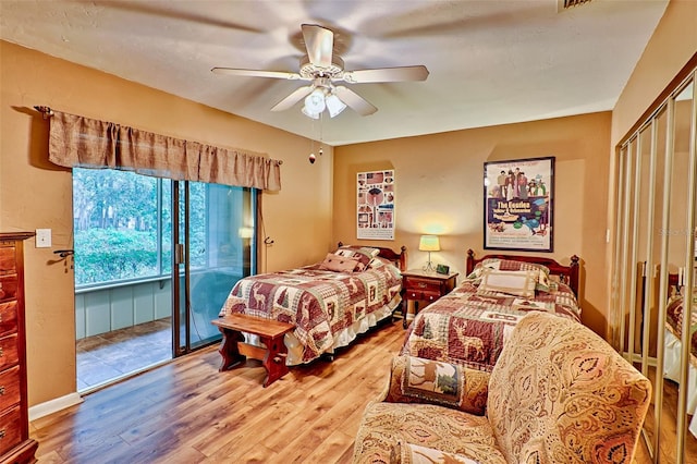 bedroom with ceiling fan, hardwood / wood-style flooring, and access to exterior