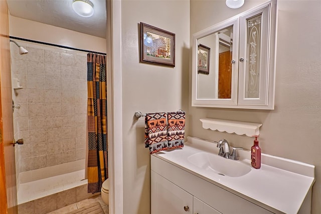 bathroom with vanity, curtained shower, toilet, and tile patterned flooring