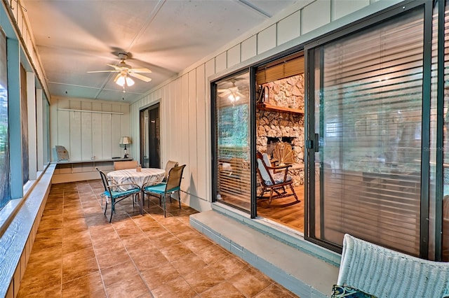 sunroom featuring ceiling fan