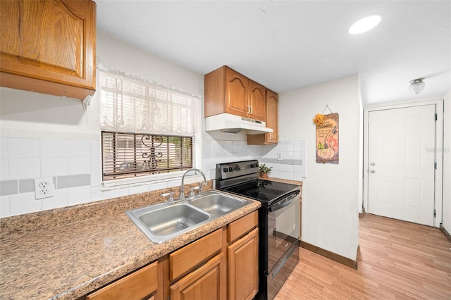 kitchen featuring black electric range, backsplash, sink, and light wood-type flooring