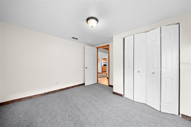 unfurnished bedroom with a closet and carpet floors