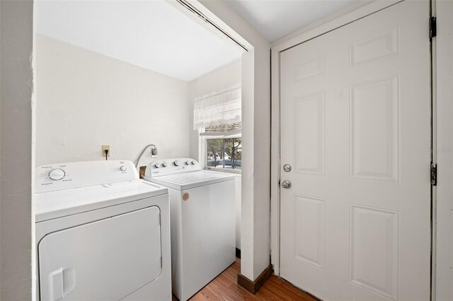 laundry room featuring independent washer and dryer and wood-type flooring