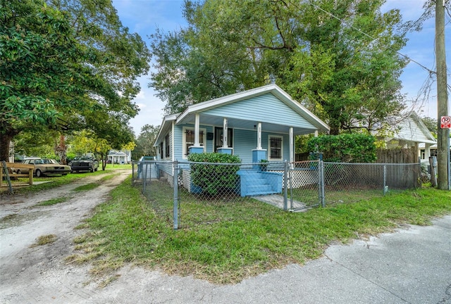 bungalow-style home with a porch and a front yard