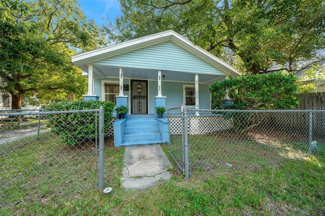 bungalow-style house featuring a front yard and covered porch