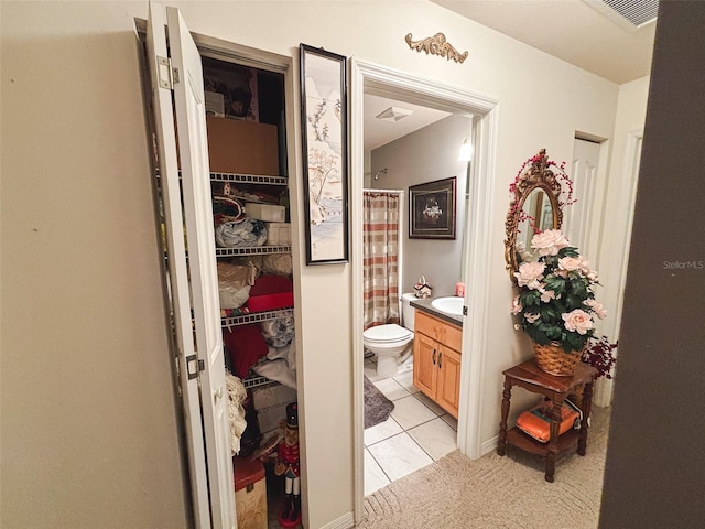 bathroom featuring vanity, toilet, and tile patterned floors