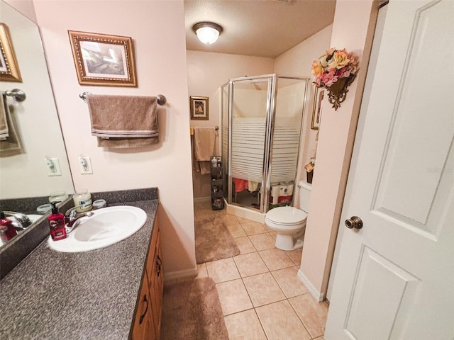 bathroom featuring vanity, toilet, walk in shower, and tile patterned flooring