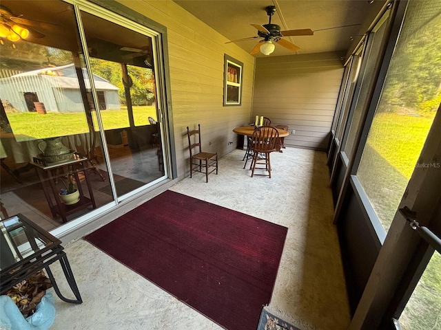 sunroom featuring ceiling fan