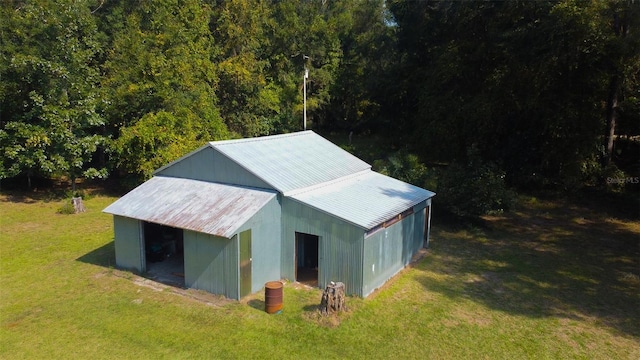 view of outbuilding featuring a yard