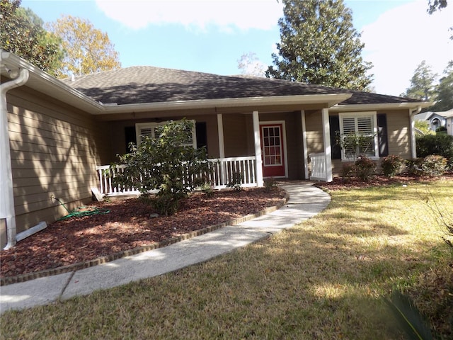 ranch-style house with covered porch and a front yard