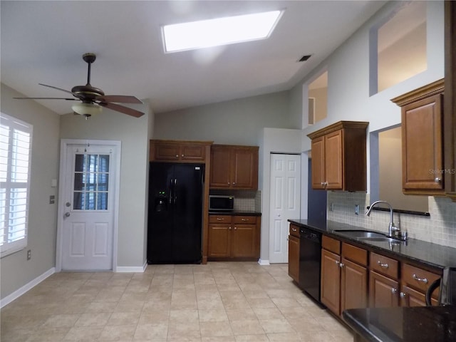 kitchen with vaulted ceiling, black appliances, sink, and backsplash