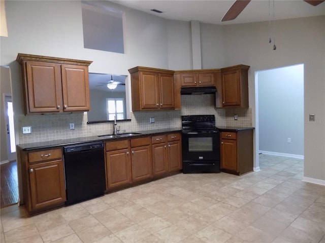 kitchen featuring sink, ceiling fan, black appliances, and a high ceiling