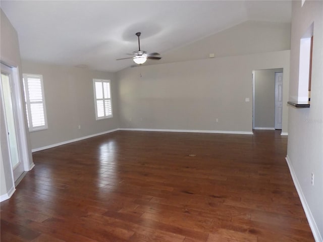 unfurnished room featuring ceiling fan, a healthy amount of sunlight, vaulted ceiling, and dark hardwood / wood-style floors