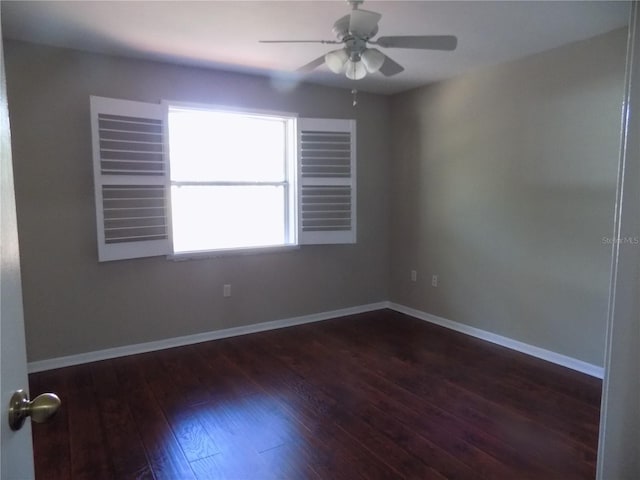 unfurnished room featuring ceiling fan and dark hardwood / wood-style flooring