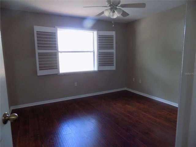 empty room with dark wood-type flooring and ceiling fan