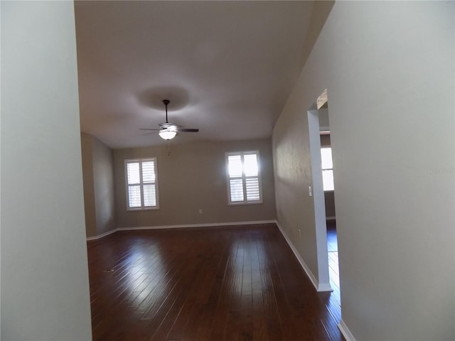 spare room featuring ceiling fan and dark hardwood / wood-style floors