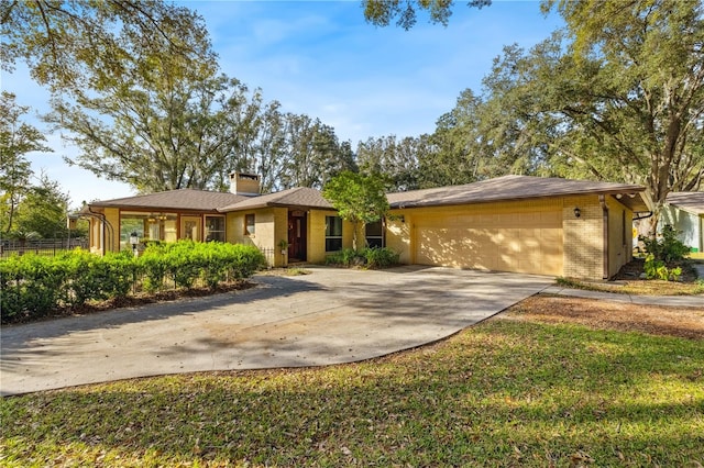 single story home featuring a front yard and a garage