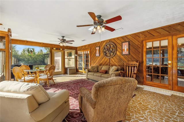 living room with wooden walls and ceiling fan