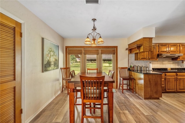 dining room featuring a chandelier and light wood-type flooring