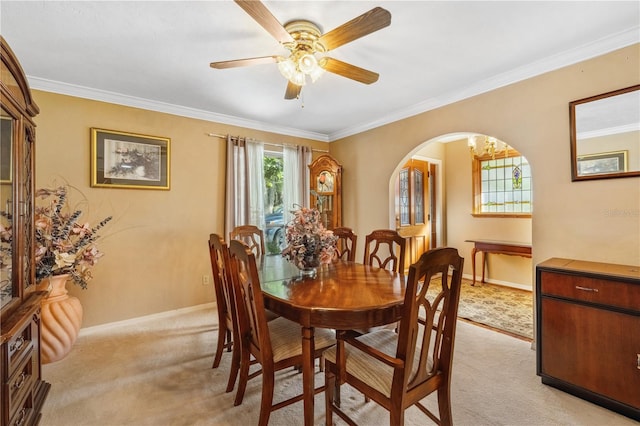 dining room featuring light carpet, crown molding, and ceiling fan with notable chandelier