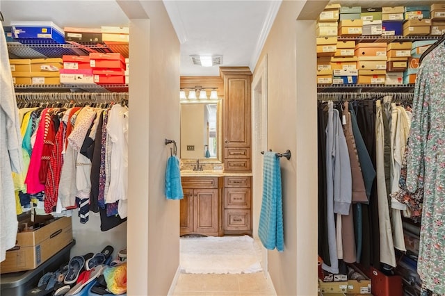 walk in closet with tile patterned flooring