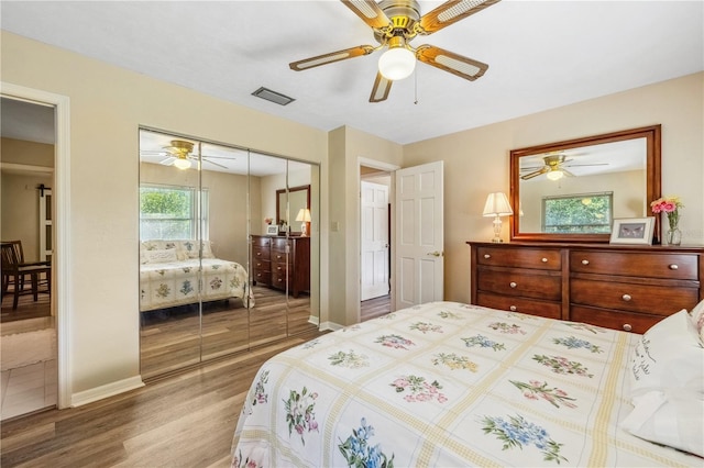 bedroom featuring hardwood / wood-style flooring, a closet, and ceiling fan