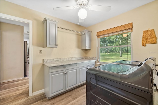 kitchen featuring gray cabinets, light hardwood / wood-style flooring, and stainless steel refrigerator