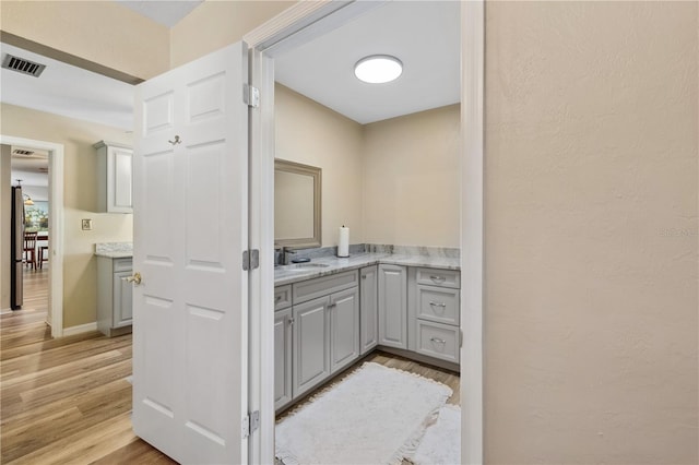 bathroom with vanity and hardwood / wood-style floors