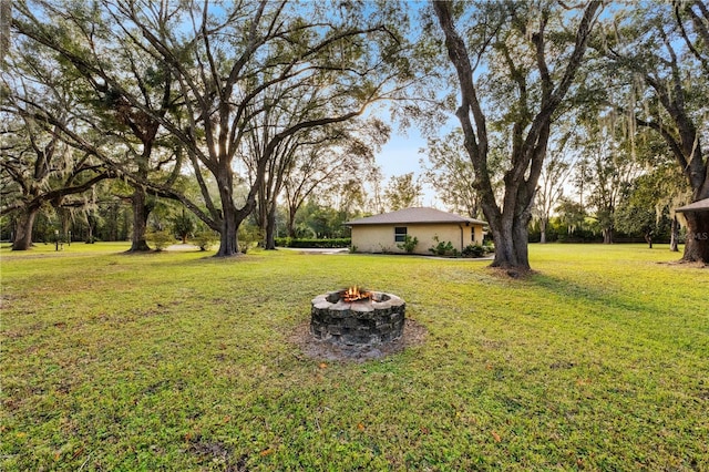 view of yard with an outdoor fire pit