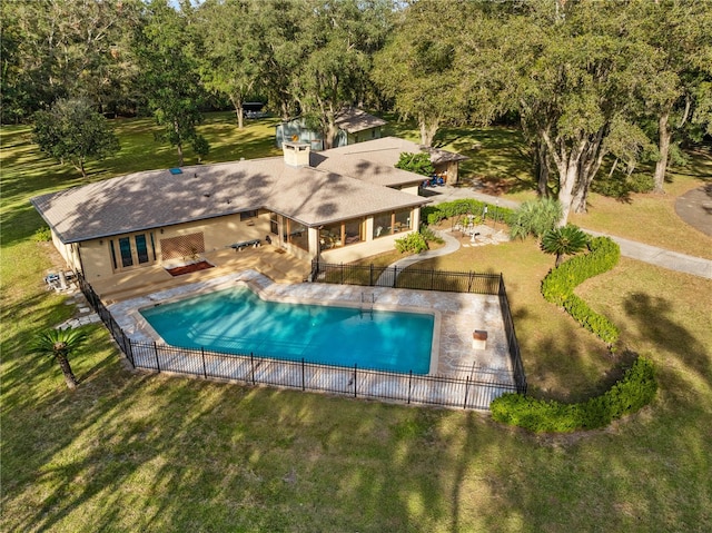 view of swimming pool featuring a patio and a lawn