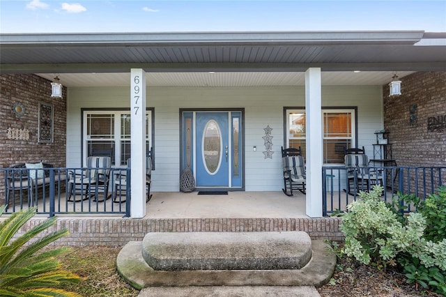 view of exterior entry with covered porch