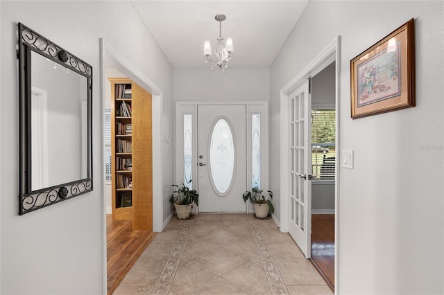 entrance foyer featuring light hardwood / wood-style flooring and a notable chandelier