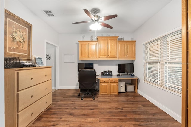 office area featuring dark hardwood / wood-style flooring, built in desk, and ceiling fan