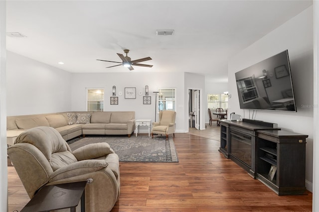 living room featuring hardwood / wood-style floors and ceiling fan