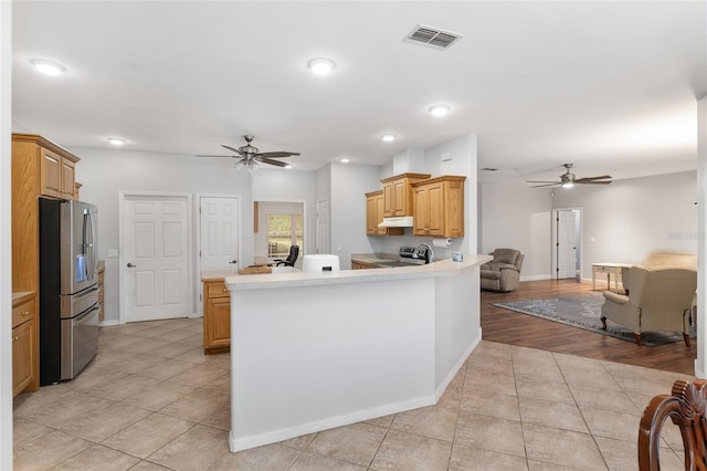 kitchen featuring light hardwood / wood-style flooring, kitchen peninsula, ceiling fan, and stainless steel appliances