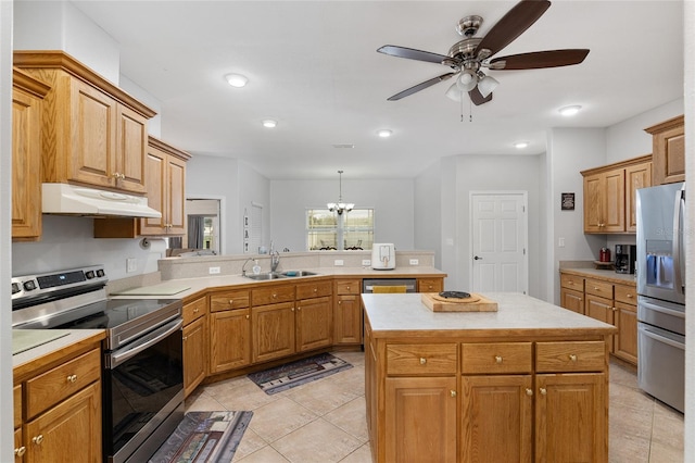 kitchen featuring ceiling fan with notable chandelier, a center island, sink, light tile patterned floors, and appliances with stainless steel finishes