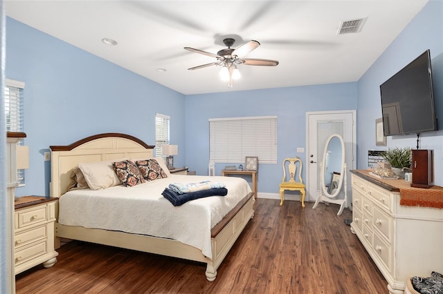 bedroom with dark hardwood / wood-style flooring and ceiling fan