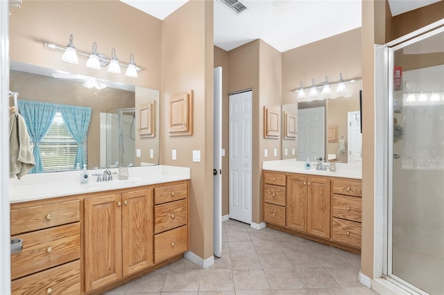 bathroom featuring walk in shower, tile patterned flooring, and vanity