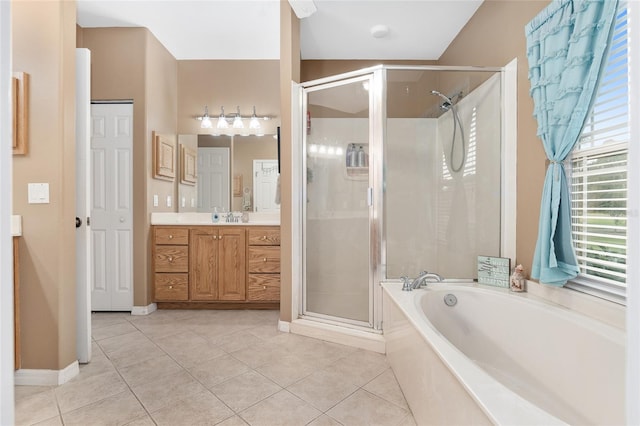 bathroom featuring independent shower and bath, vanity, and tile patterned floors