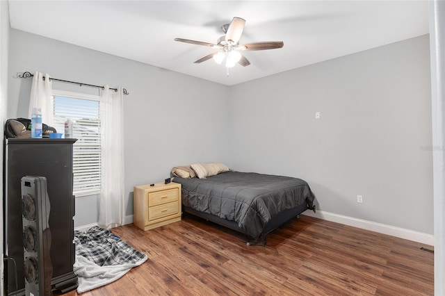 bedroom featuring dark hardwood / wood-style flooring and ceiling fan