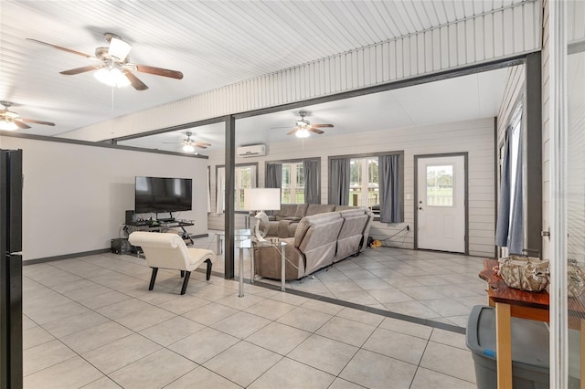 living room featuring light tile patterned flooring and a wall mounted air conditioner